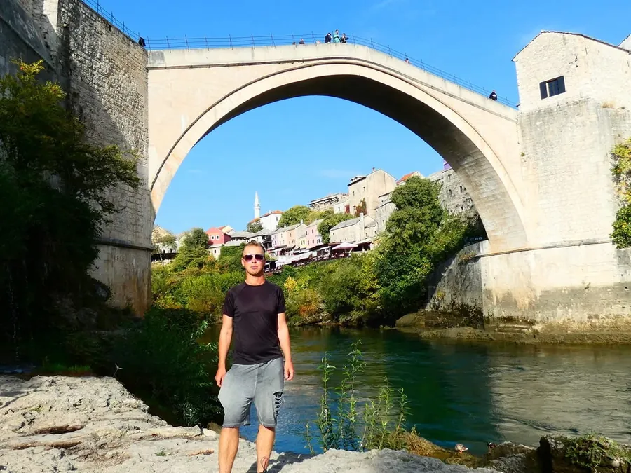 Standing beside the Old Bridge (Stari Most) in Mostar, Bosnia and Herzegovina